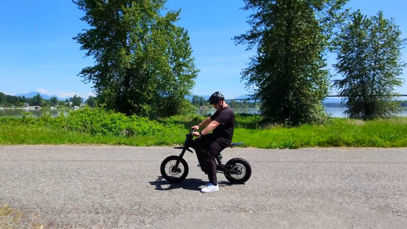 Riding the Heybike Villain along a gravel dyke trail