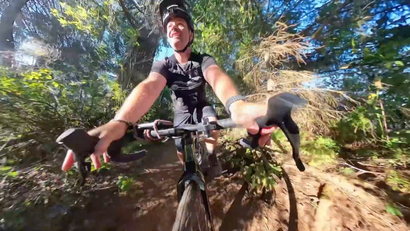 Riding the CF Racer1 down a green singletrack trail