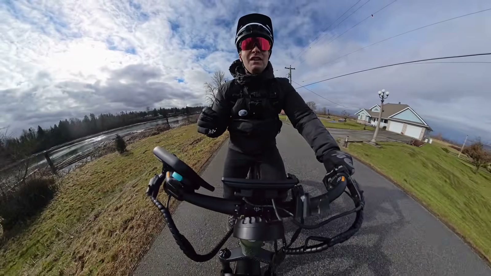 Ben riding the Nomad 2 along a riverside road